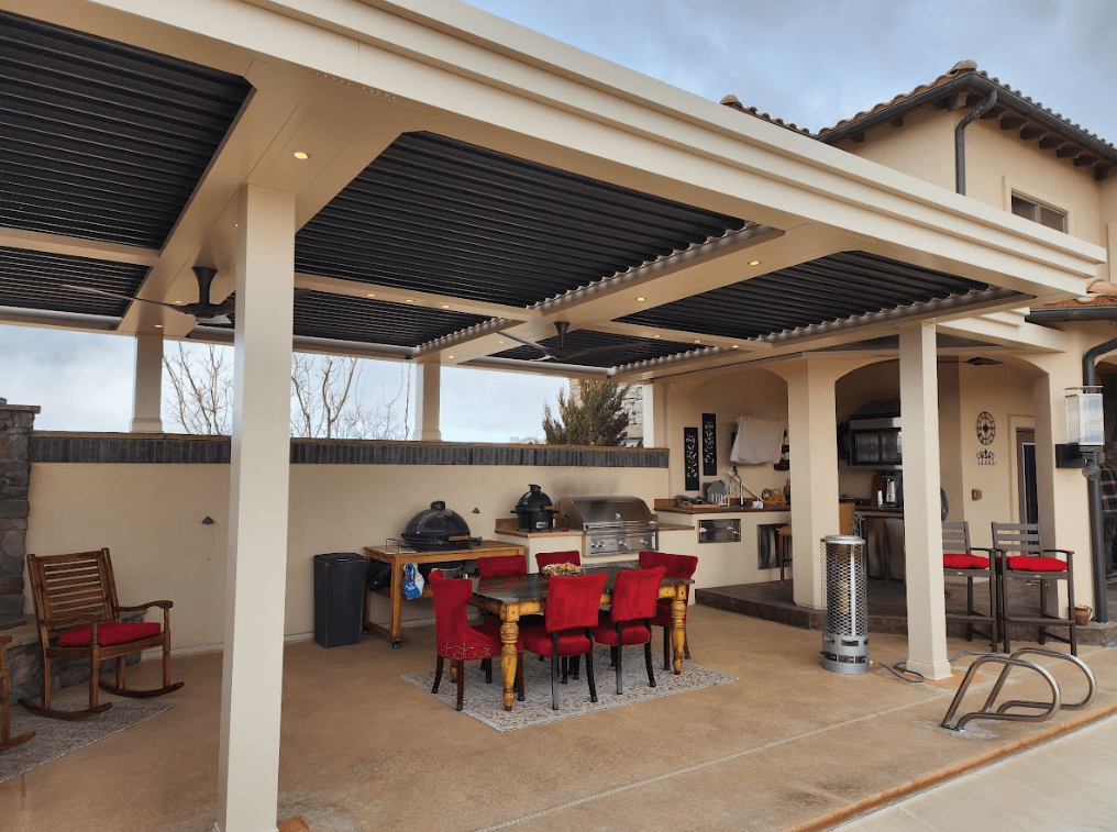 Photo of a patio with a louvered roof pergola and outdoor kitchen as outdoor living features