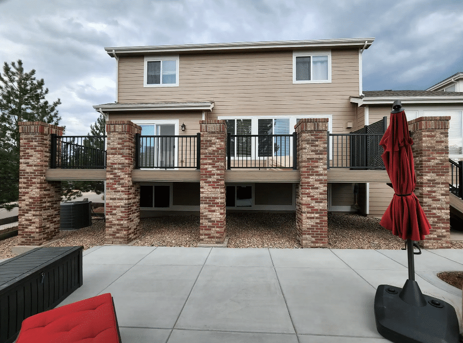 photo-of-a-raised-deck-with-deck-railing-and-brick-columns - Patio covers contractors and patio builders in colorado