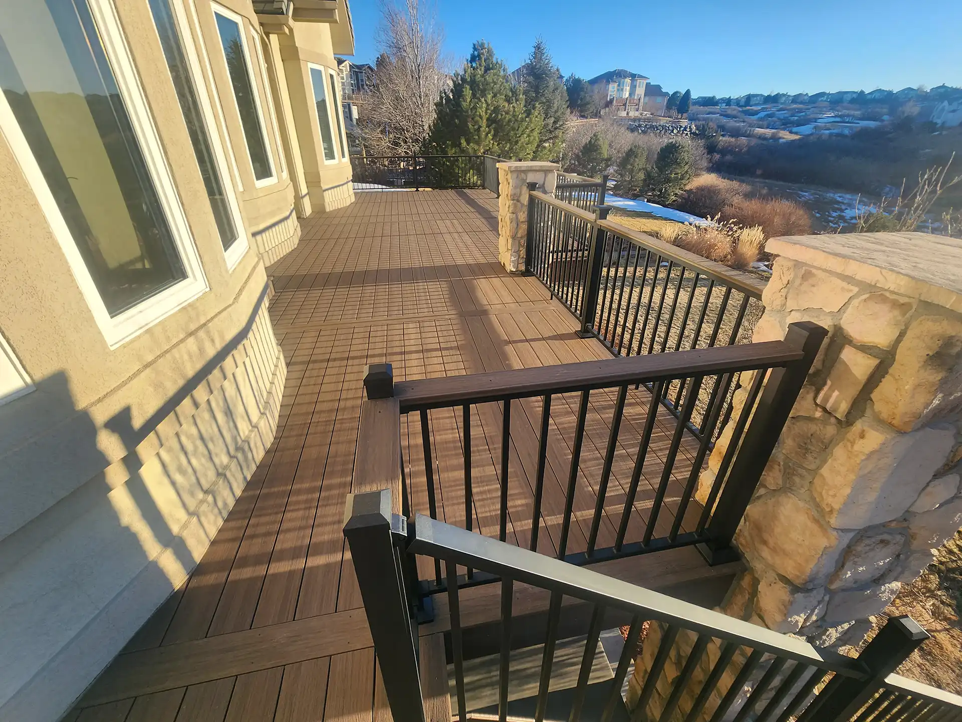 photo oa custom elevated deck with railing and stone columns