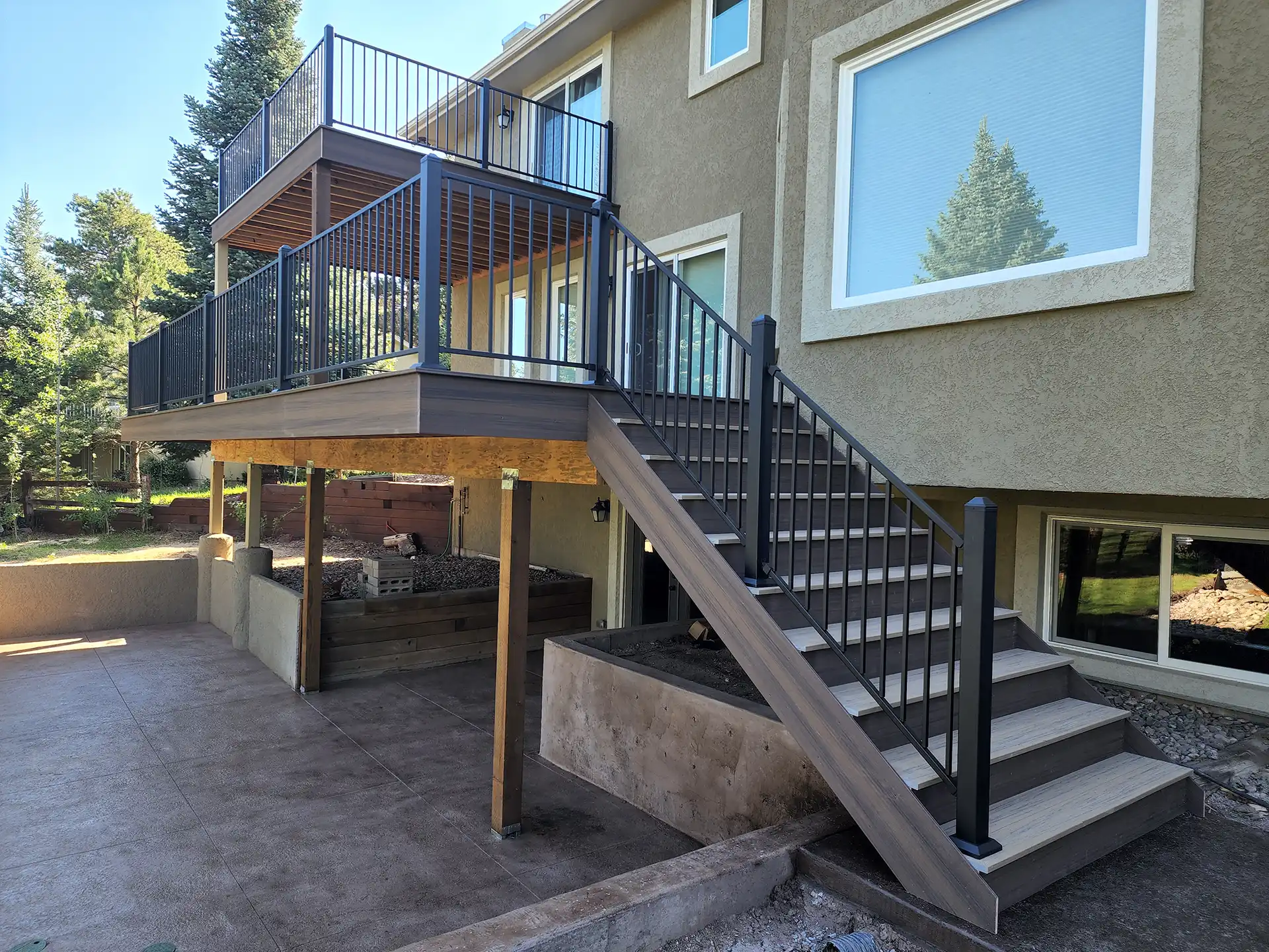 Photo of a raised deck with a balcony deck and patio underneath