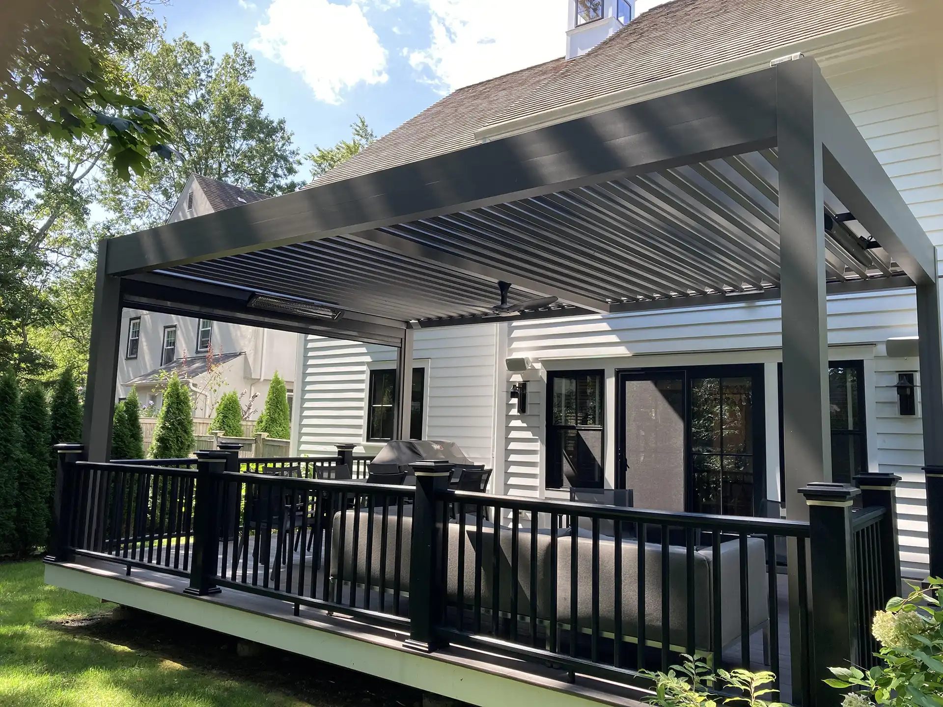 photo of an Azenco R-Blade pergola providing cover for a custom deck