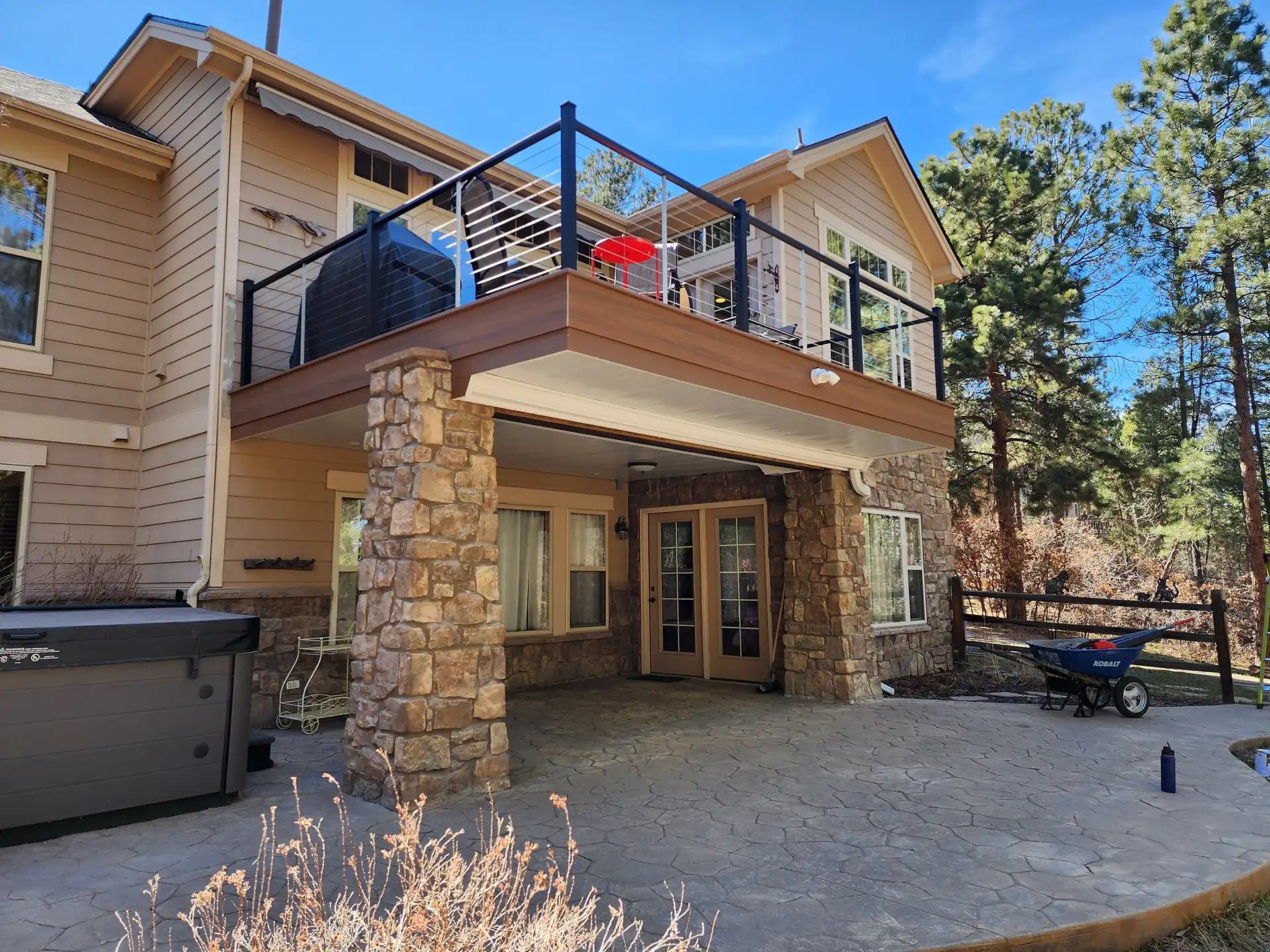 photo of an elevated deck with an under deck waterproofing system that creates a dry space for the patio beneath