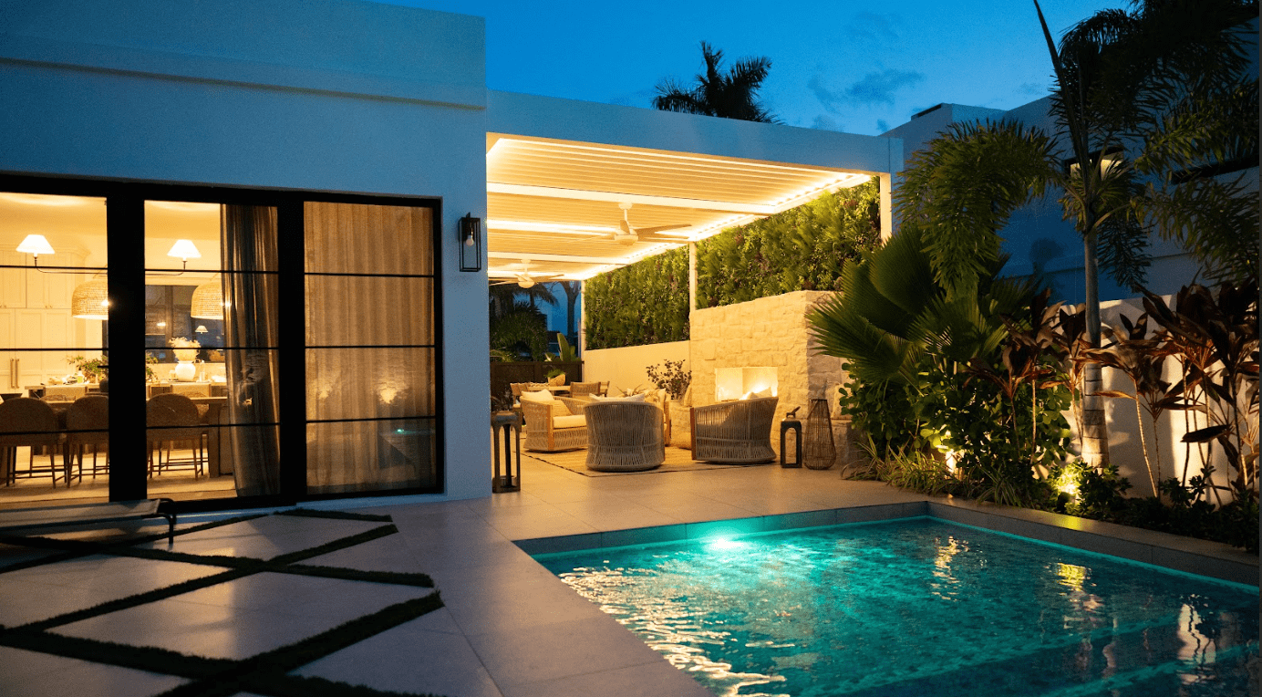 Azenco louvered roof pergola providing cover for outdoor living room next to a built-in pool - Custom Pergola Builders in Black Forest Colorado