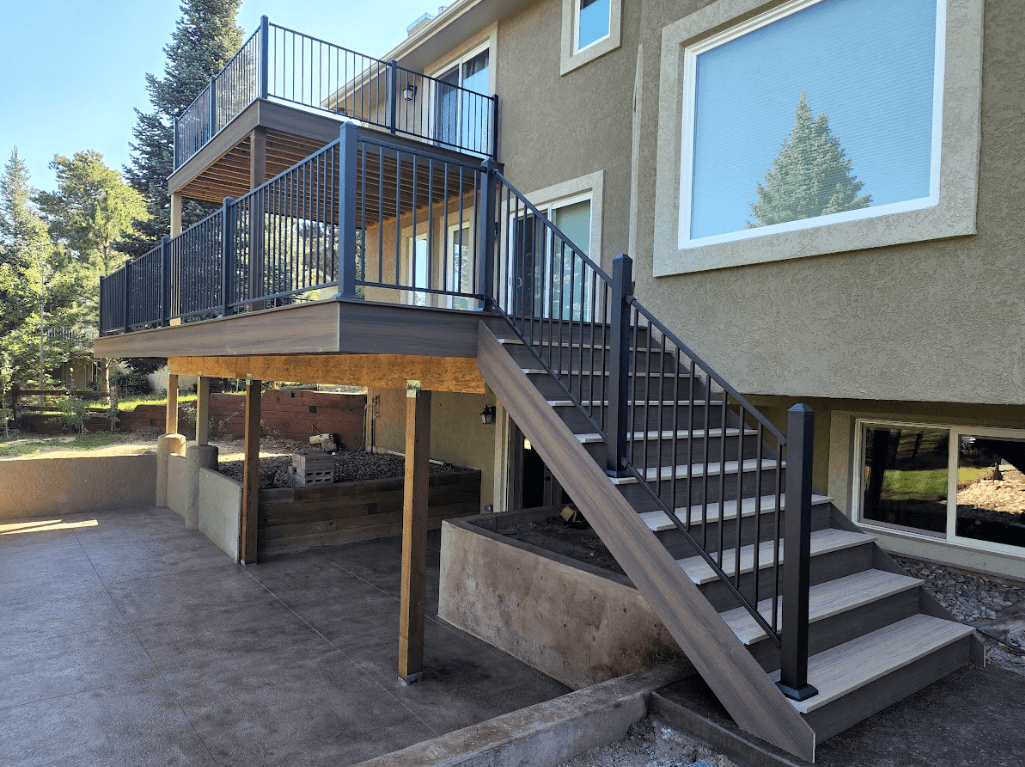 raised deck with a balcony deck and patio underneath - Custom Deck Builders near me in Elizabeth Colorado