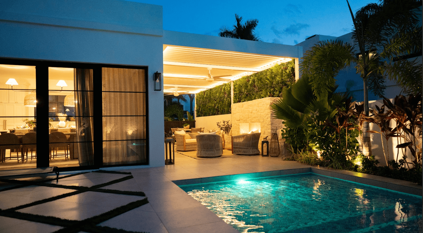 Azenco louvered roof pergola providing cover for outdoor living room next to a built-in pool - Custom pergola builders and louvered pergolas contractors near me in Elizabeth Colorado