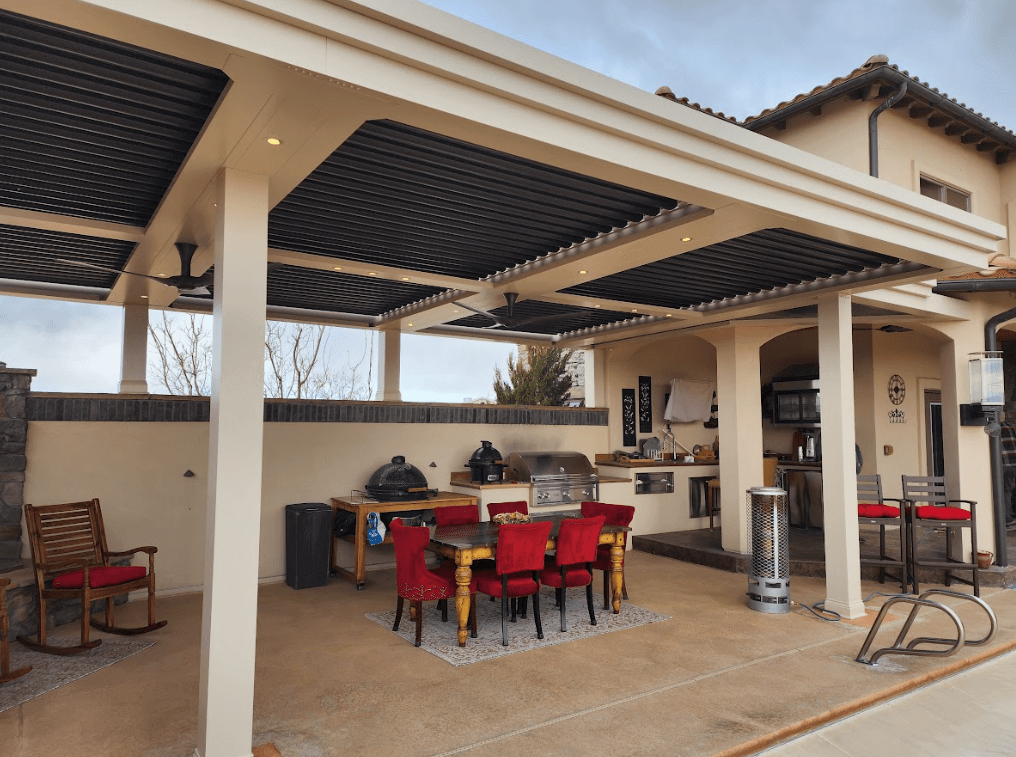 photo of a commercial louvered roof pergola with outdoor kitchen and dining furniture - Louvered pergola near me in Colorado