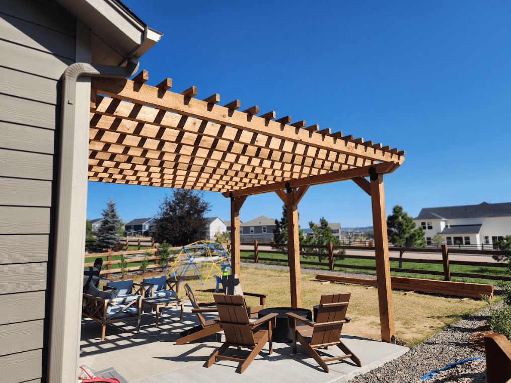 photo of a traditional wooden pergola providing limited shade on a patio with outdoor furniture - Wooden patio cover - Low maintenance options and solutions