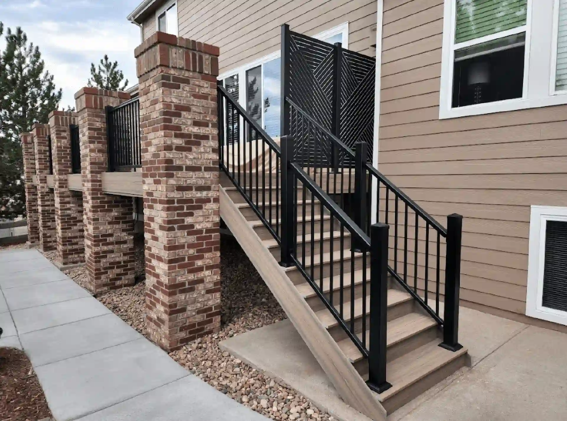 photo of a raised deck with deck railing privacy screen deck steps and brick columns - Outdoor Privacy Screen Ideas