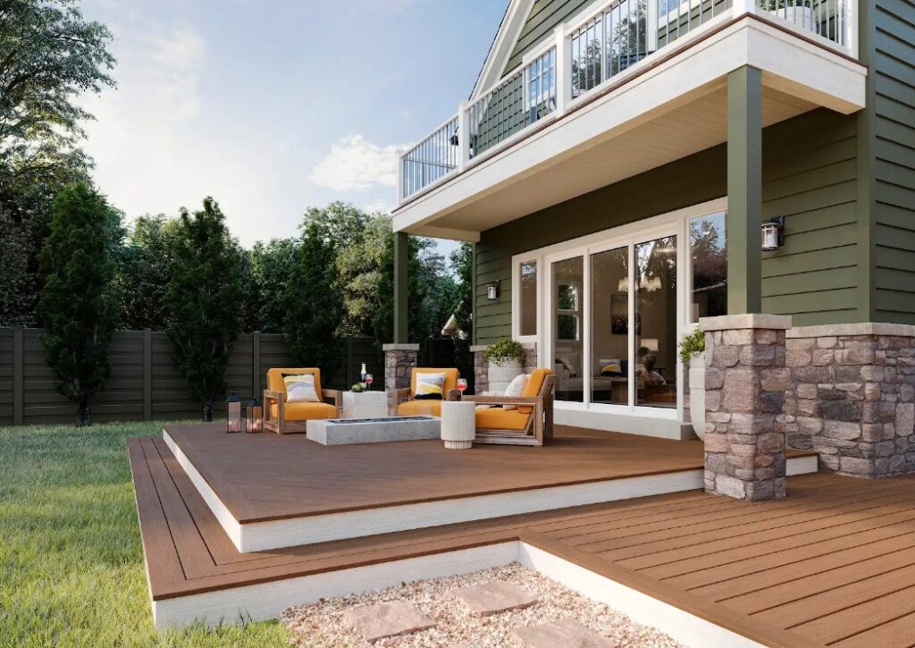 Modern ground-level composite deck attached to a Colorado home featuring low-maintenance decking, outdoor lounge seating, and contemporary backyard living space