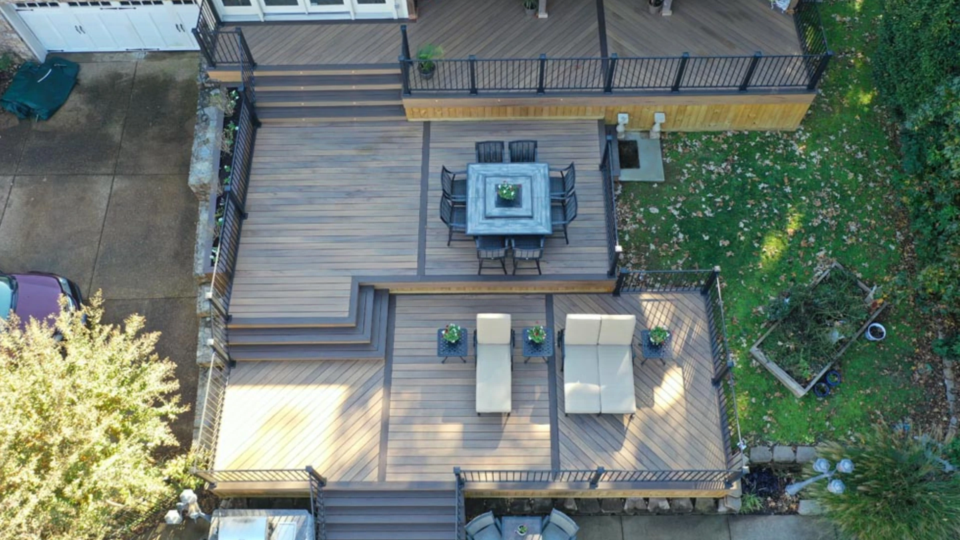 aerial-view-of-the-multi-level-residential-deck-framing-with-skirting-and-black-metal-railing-with-outdoor-living-dining-set-area-and-lounge-in-castle-rock-co