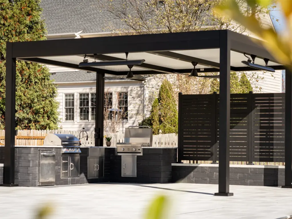 black-louvered-pergola-with-lighting-and-covered-outdoor-living-kitchen-beside-the-privacy-wall-screen-in-castle-rock-co