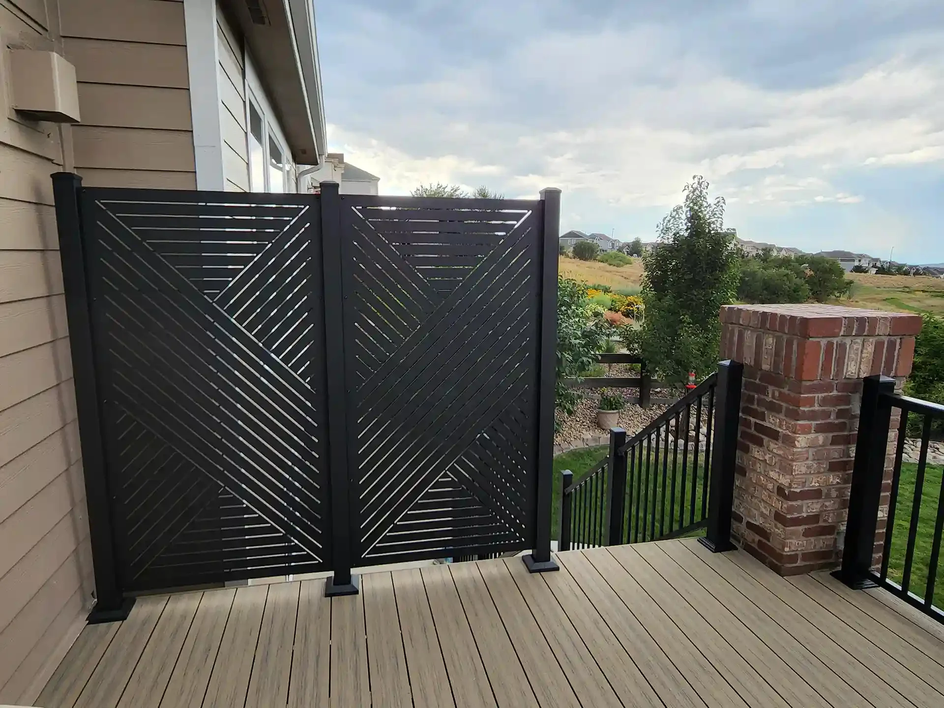 black-privacy-panel-screen-on-the-pvc-deck-with-black-metal-railings-and-brick-pillars-featuring-overlooking-view-in-castle-rock-co
