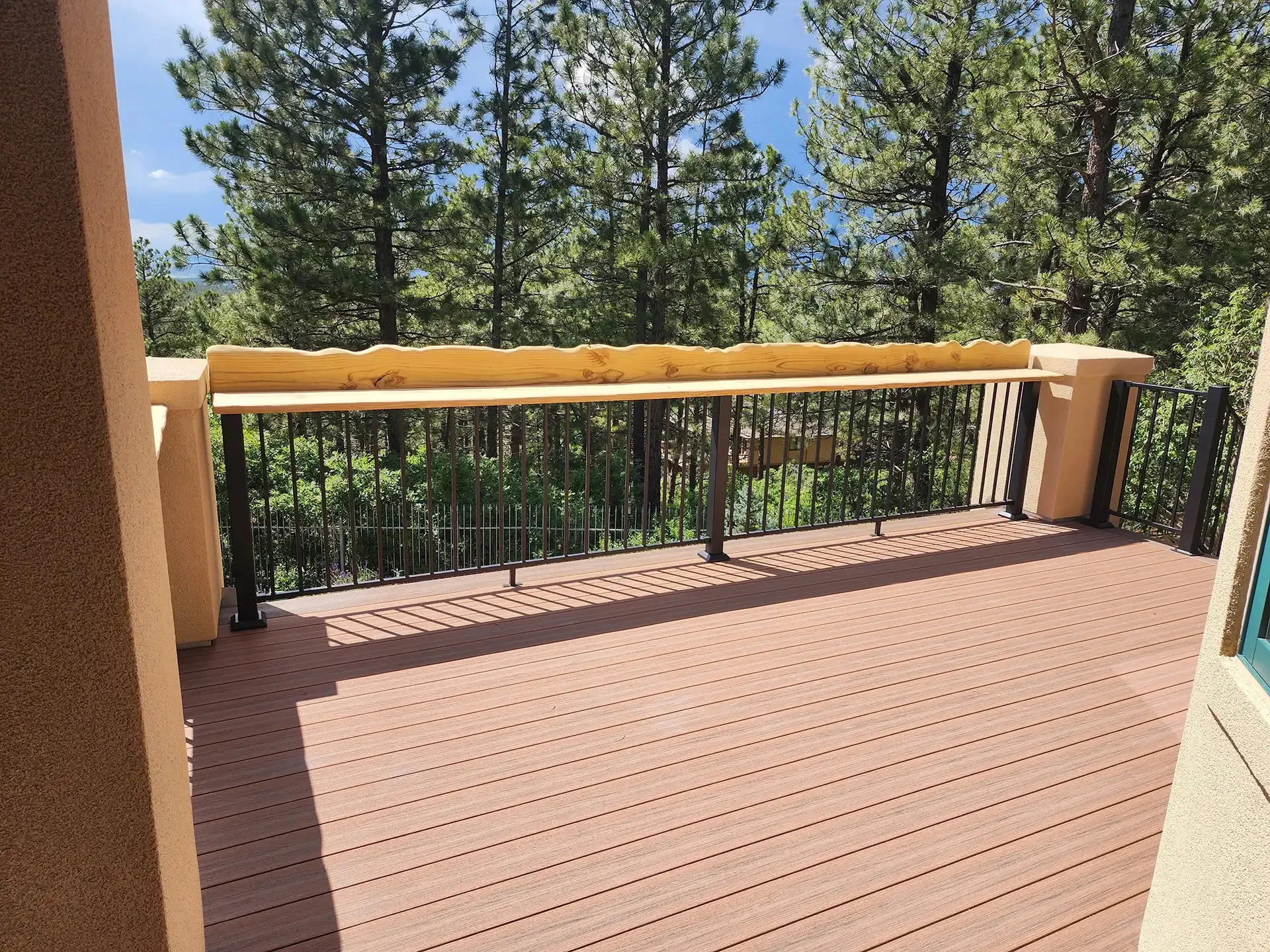 commercial-deck-with-black-railing-and-decorative-wood-with-big-trees-on-the-background-in-douglas-co
