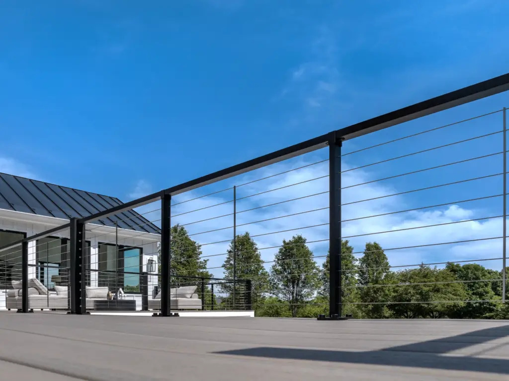composite-deck-with-cable-railings-and-outdoor-living-lounge-featuring-big-trees-and-cloudy-sky-on-the-background-in-castle-rock-co