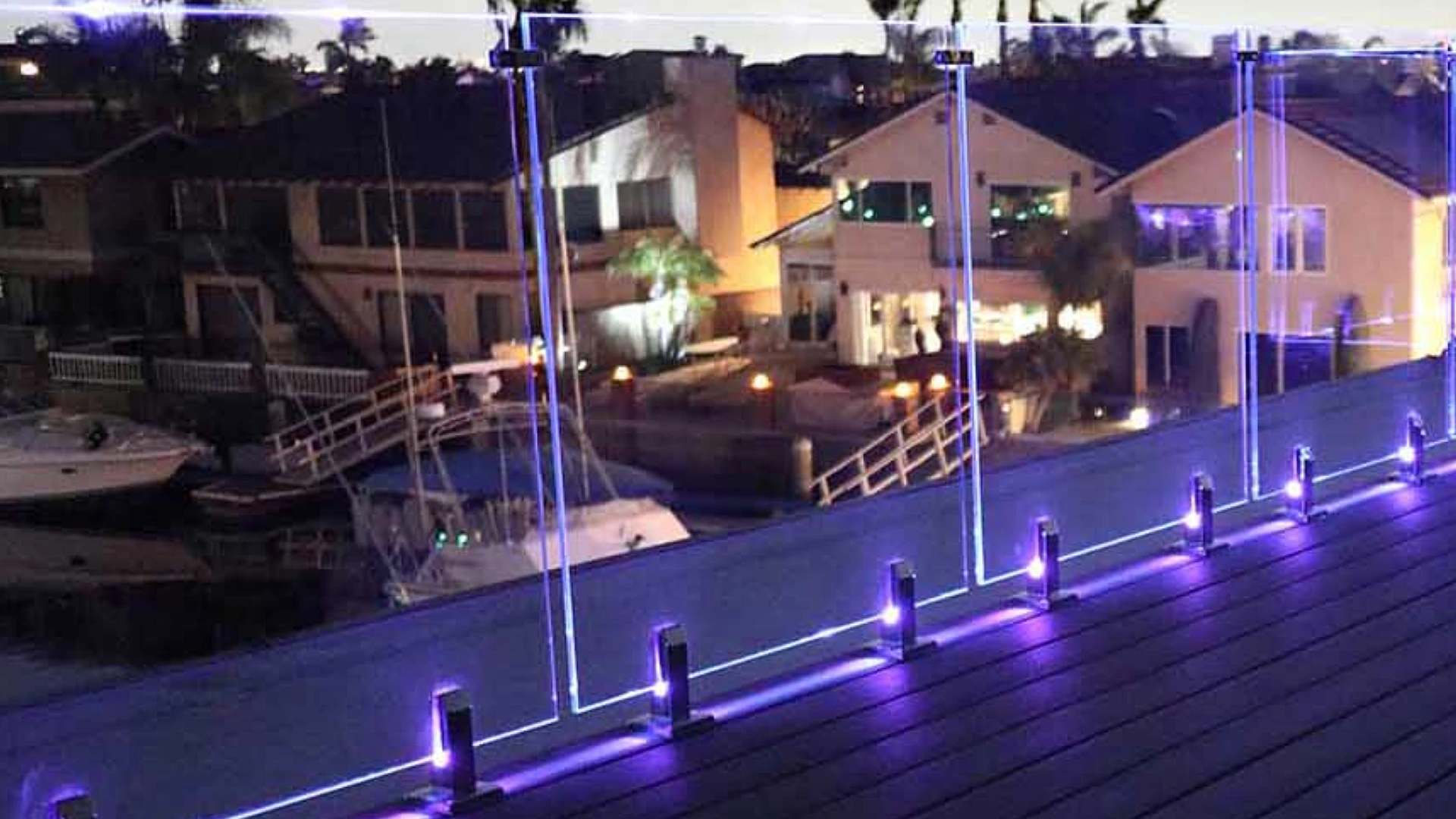 custom-commercial-deck-with-lights-on-glass-railing-featuring-residential-houses-and-boat-on-the-background-in-castle-rock-co