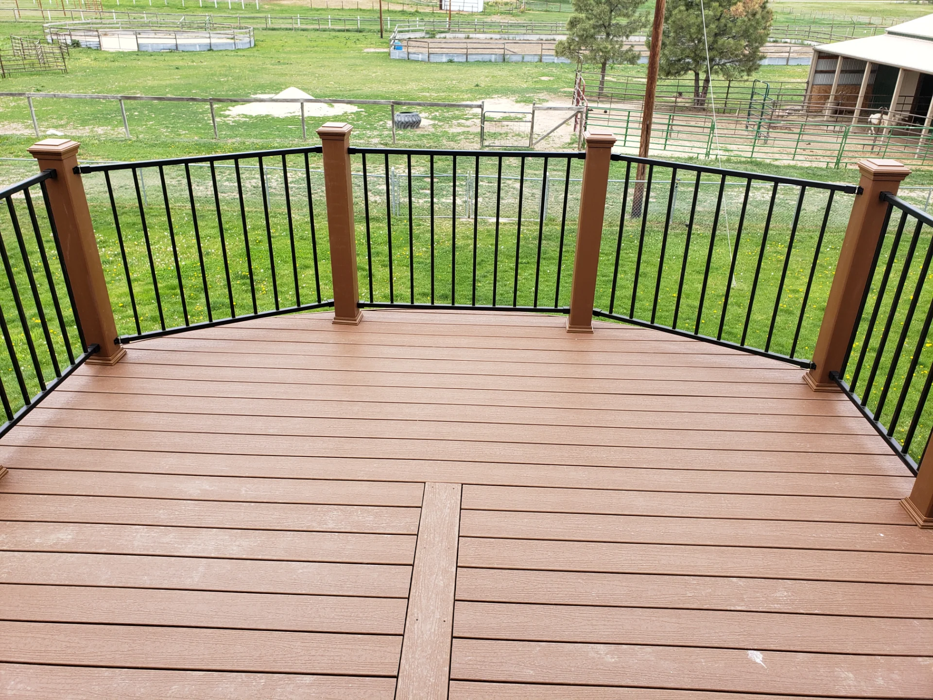 custom-commercial-decking-on-the-backyard-of-the-house-with-black-railing-and-brown-composite-post-cap-lights-in-douglas-co