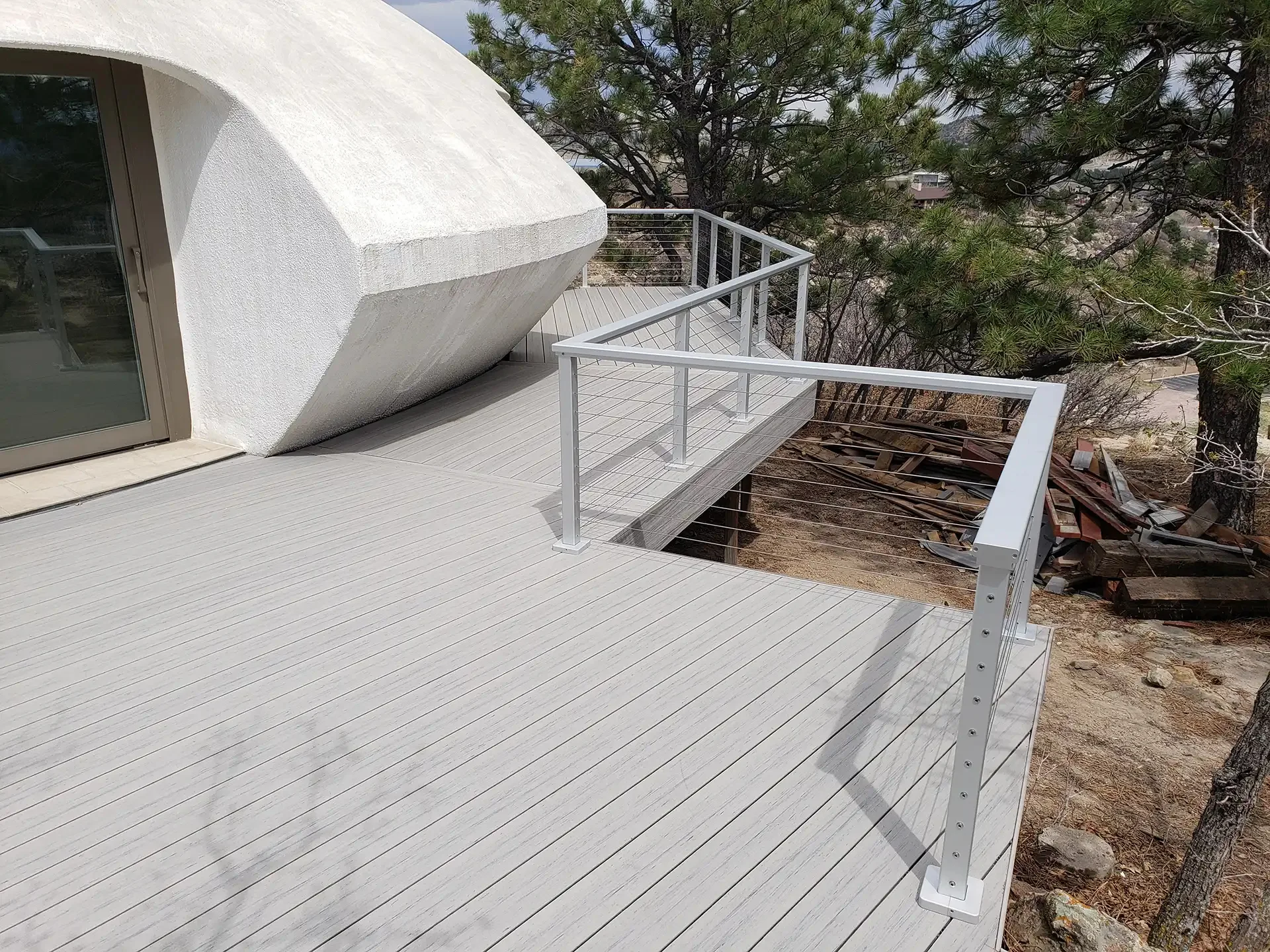 custom-gray-wooden-deck-with-cable-railings-with-trees-on-the-background-in-castle-rock-co