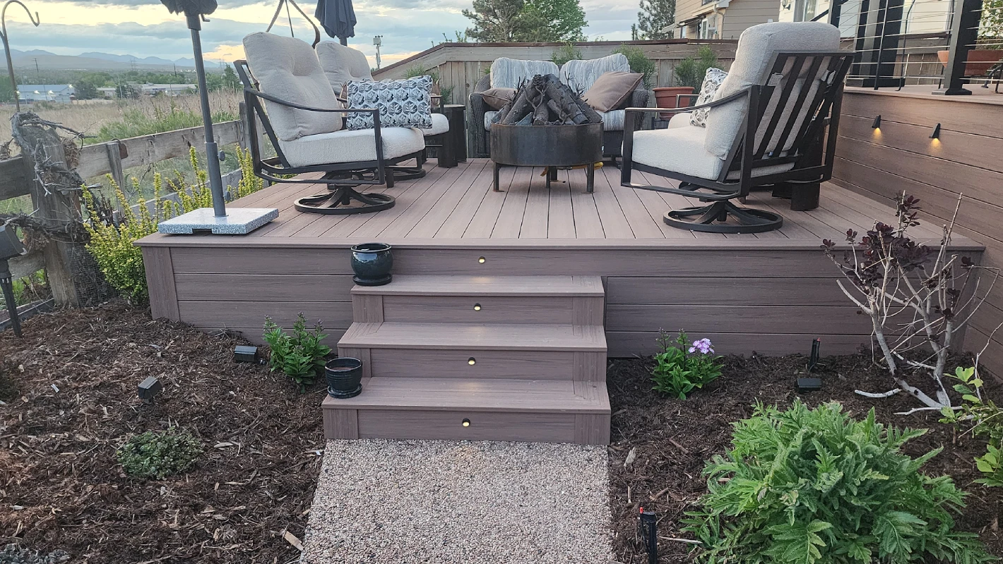custom-residential-decking-with-lights-on-steps-and-outdoor-living-lounge-and-fire-place-on-the-backyard-of-the-house-in-castle-rock-co