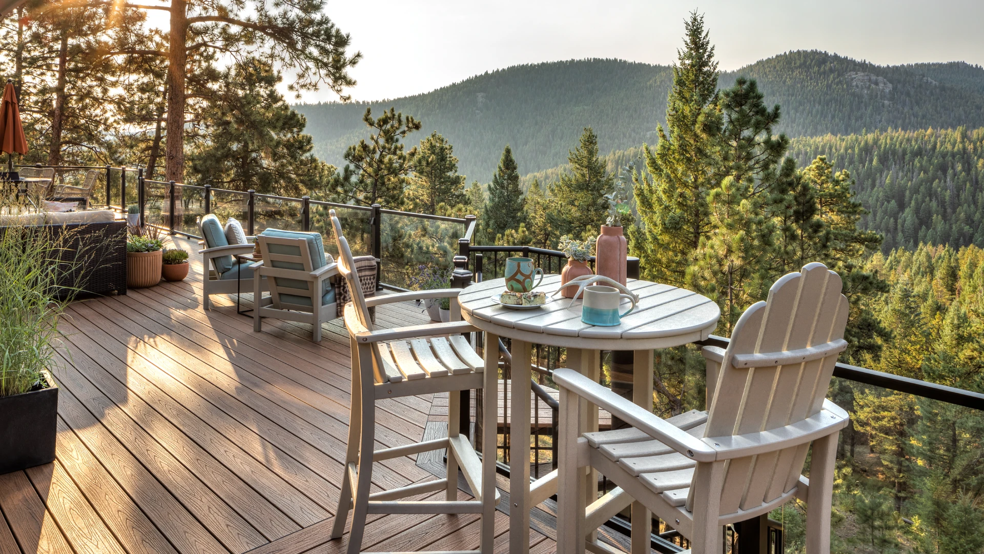 custom-rooftop-deck-with-outdoor-living-dining-area-and-seating-with-glass-railing-featuring-overlooking-nature-view-in-castle-rock-co