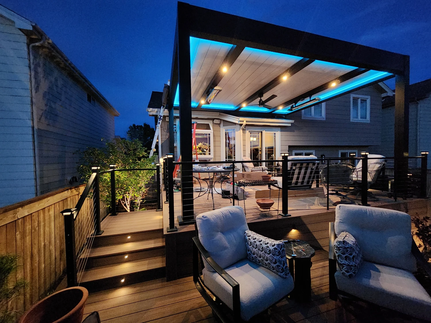 led-cabana-with-outdoor-living-lounge-and-seating-area-with-cable-railing-on-the-multi-level-deck-with-step-lights-and-wooden-wall-fence-in-castle-rock-co