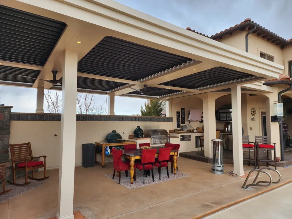outdoor-living-kitchen-and-dining-set-with-rocking-chairs-featuring-lights-on-the-ceiling-in-castle-rock-co