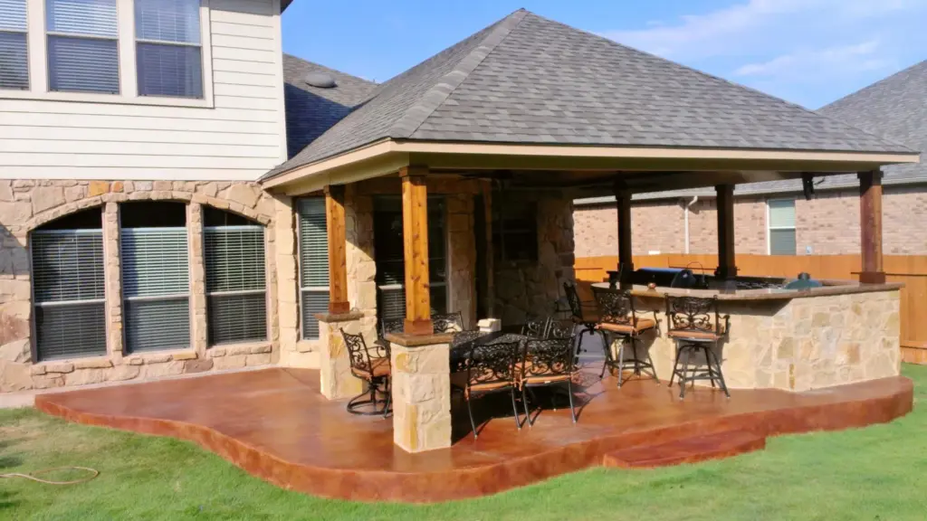 patio-construction-under-the-roof-with-outdoor-bar-on-the-backyard-of-the-house-featuring-wooden-wall-security-fence-in-castle-rock-co