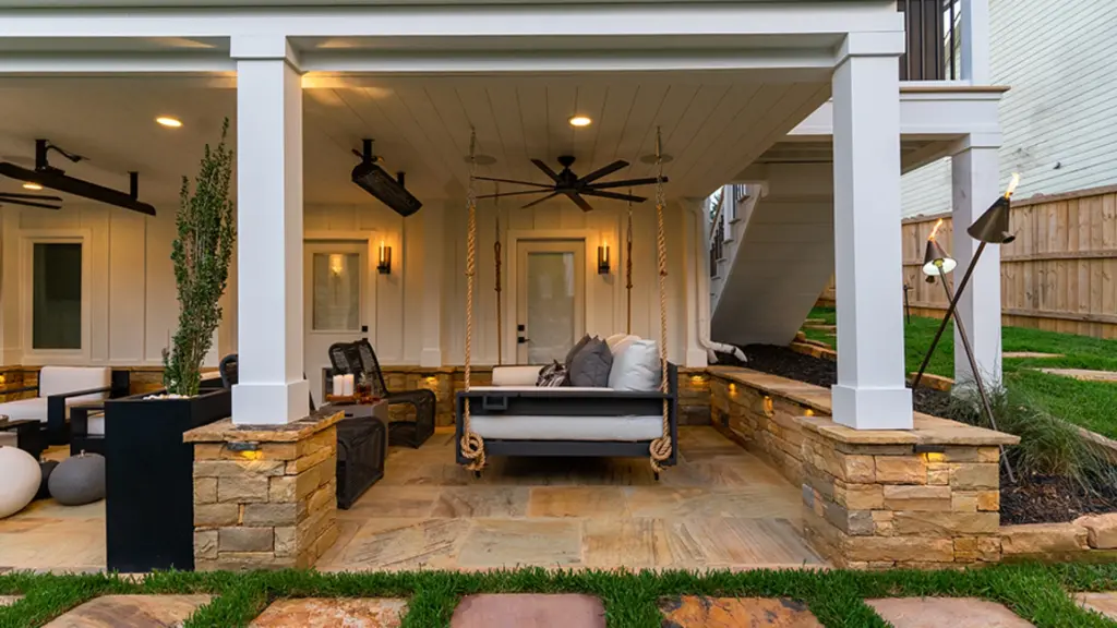 paver-patio-with-outdoor-living-sofa-with-fan-and-lighting-on-the-ceiling-with-wooden-wall-privacy-fence-on-the-side-house-in-castle-rock-co
