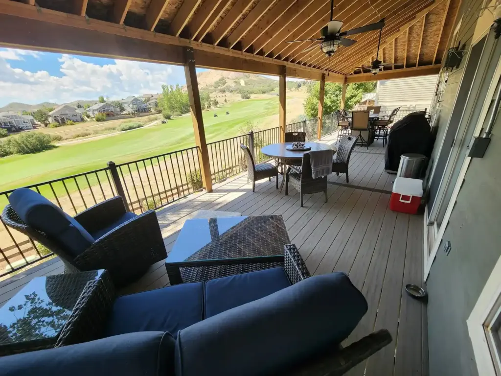 porch-featuring-a-outdoor-living-tables-and-chairs-surrounded-by-furniture-with-a-fan-on-the-wooden-ceiling-featuring-overlooking-view-in-castle-rock-co