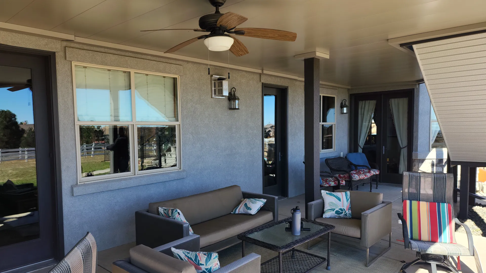 under-deck-with-water-proofing-and-outdoor-living-sofa-and-seating-area-with-a-fan-on-the-ceiling-in-castle-rock-co