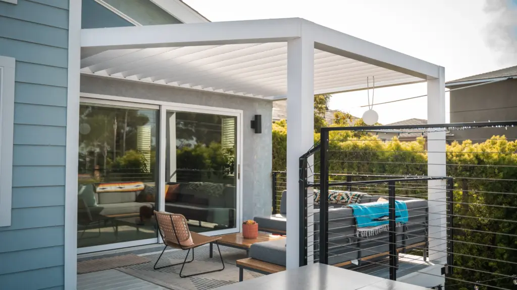 white-breeze-pergola-with-outdoor-living-lounge-and-cable-railing-featuring-trees-houses-and-cloudy-sky-view-in-castle-rock-co