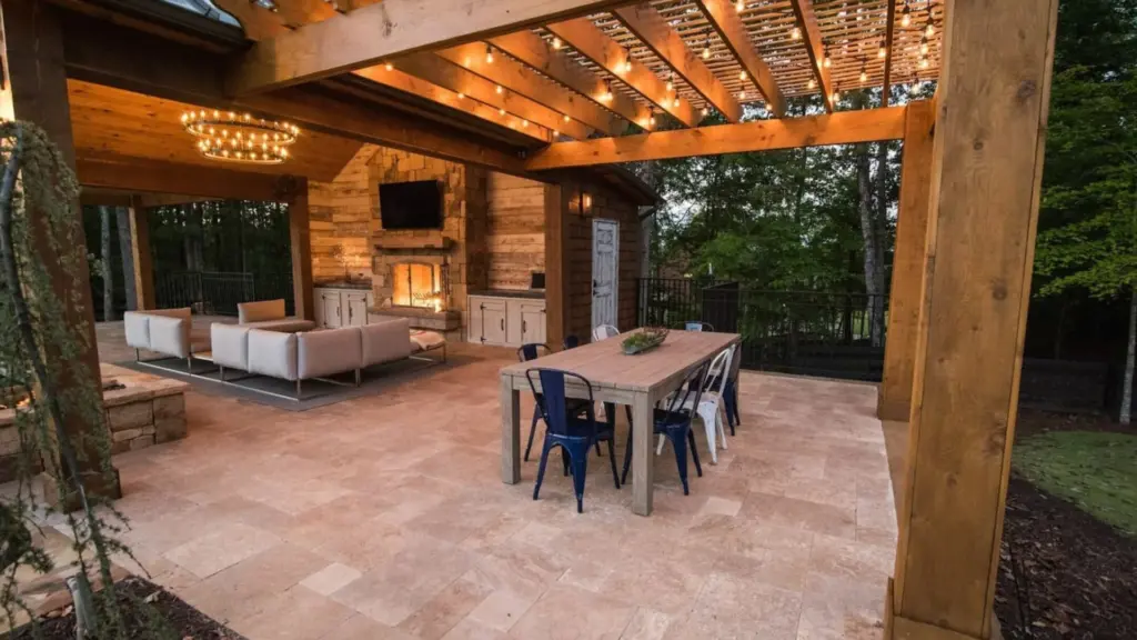 wooden-pergola-with-lighting-and-outdoor-living-dining-set-area-with-fireplace-and-tv-on-the-wall-in-castle-rock-co