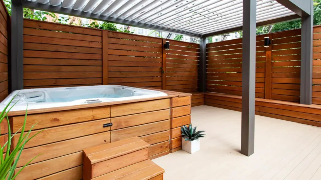 wooden-privacy-screen-on-the-black-louvered-pergola-with-custom-hot-tub-with-potted-plants-in-castle-rock-co